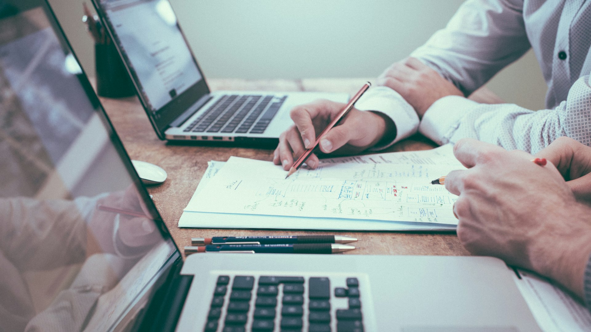 Technical documents and a laptop on a desk